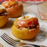 Stuffed Baked Apples on parchment paper on top of maple cutting board - the perfect fall apple dessert
