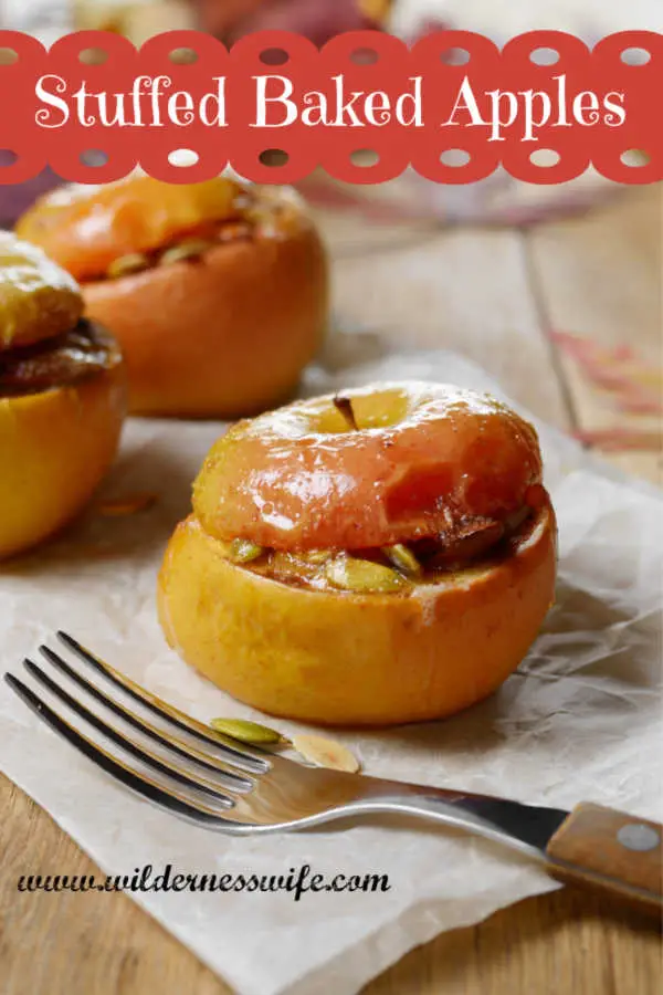 Stuffed Baked Apples on parchment paper on top of maple cutting board - the perfect fall apple dessert