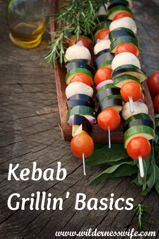  vegetable kebabs ready for the grill setting on a wooden table