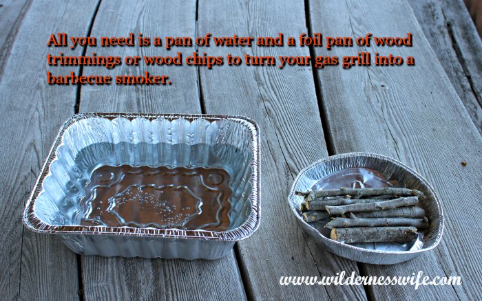 Foil pan of water and foil pan of green apple wood ready to be put into the gas grill to turn it into a barbecue smoker.