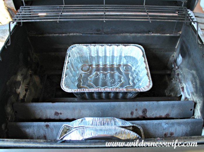 Pan of water and pan of apple wood in the gas grill turning it into a barbecue smoker.