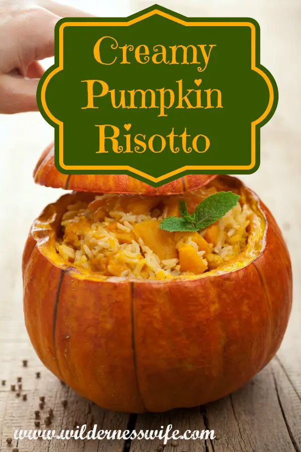 A pupkin stuffed Creamy Slow Cooker Pupmpkin Risotto ready to be a dramatic centerpiece for the Thanksgiving Table.