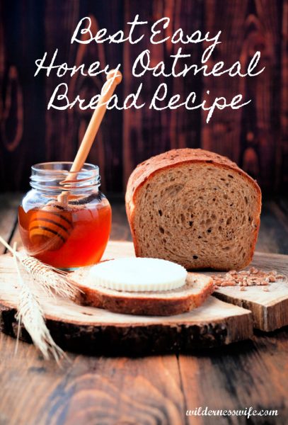 Best Easy Honey Oatmeal Bread Recipe with loaf on cutting board next to jar of honey