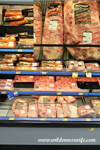 Meat case in store showing a selection of pork for barbecuing.