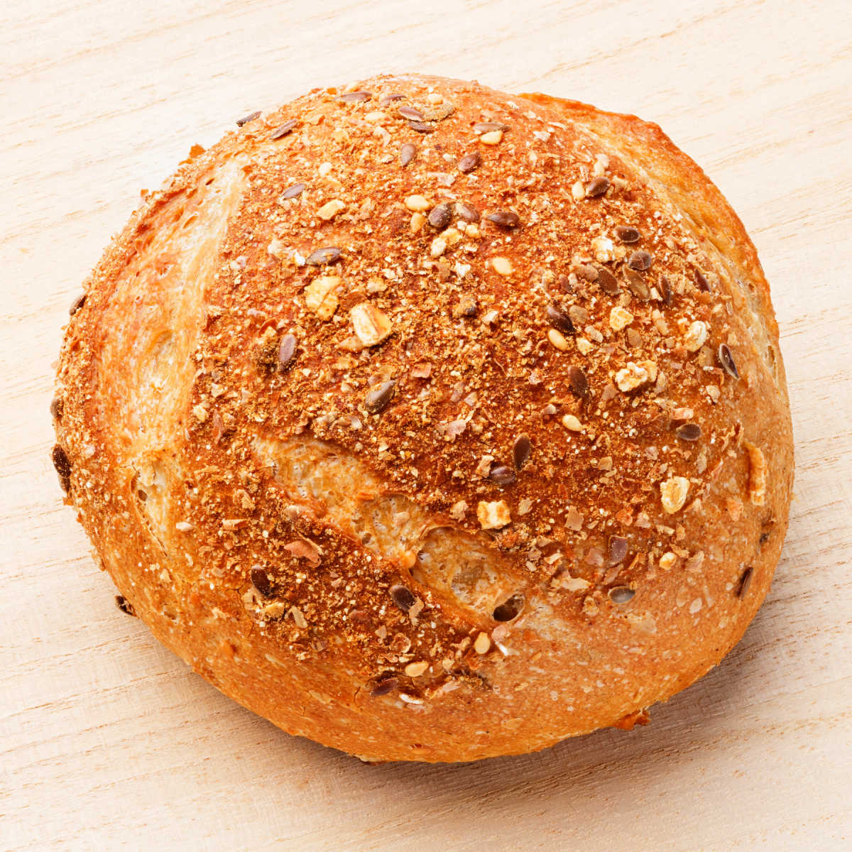 Slow Cooker Multi Grain Bread loaf on wood table