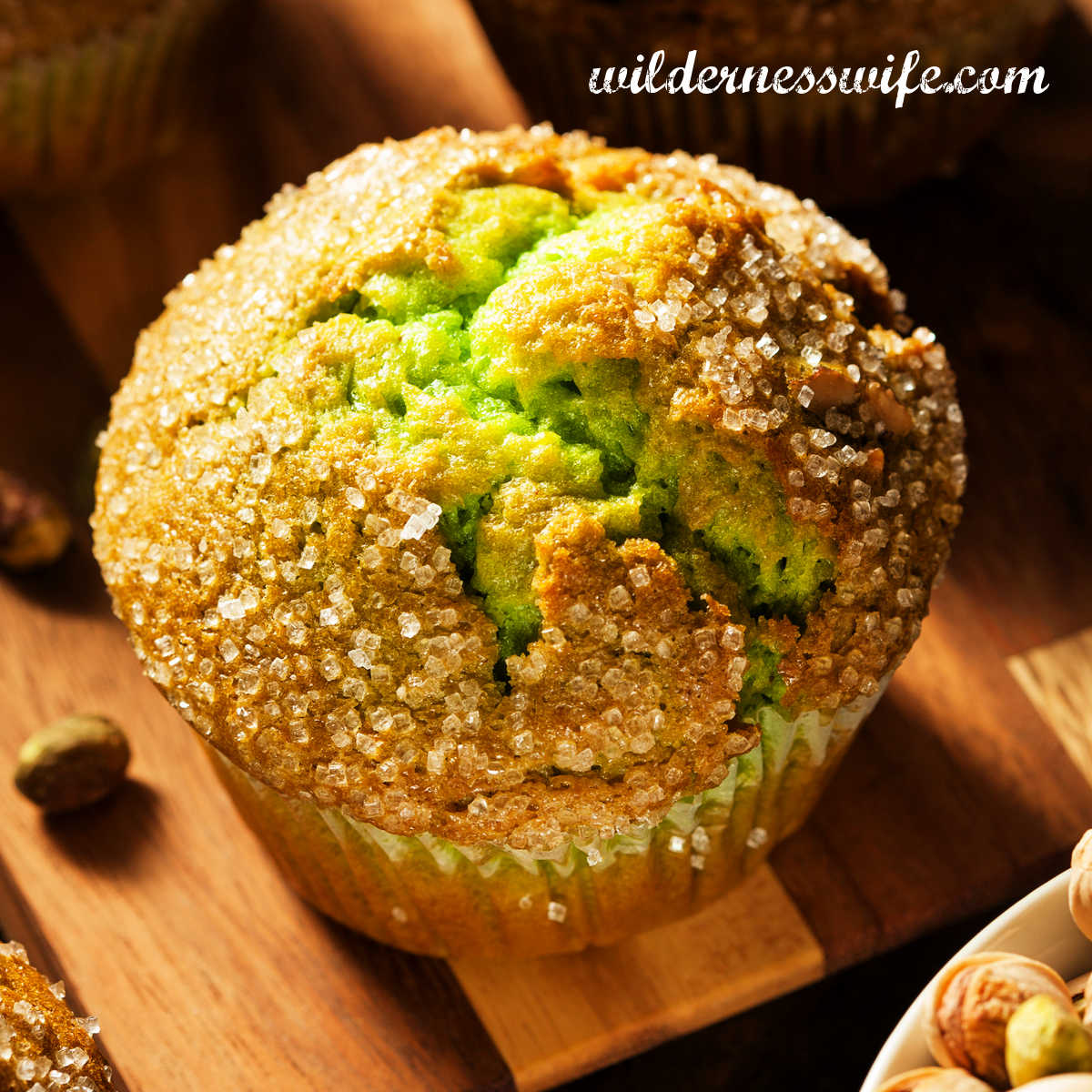 Pistachio muffin on wooden cutting board