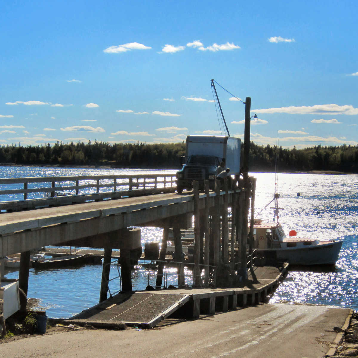 Maine lobster boat unloading at town dock in Machiasport