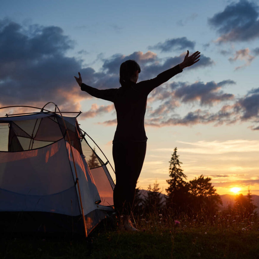 Woman at campsite at sunset