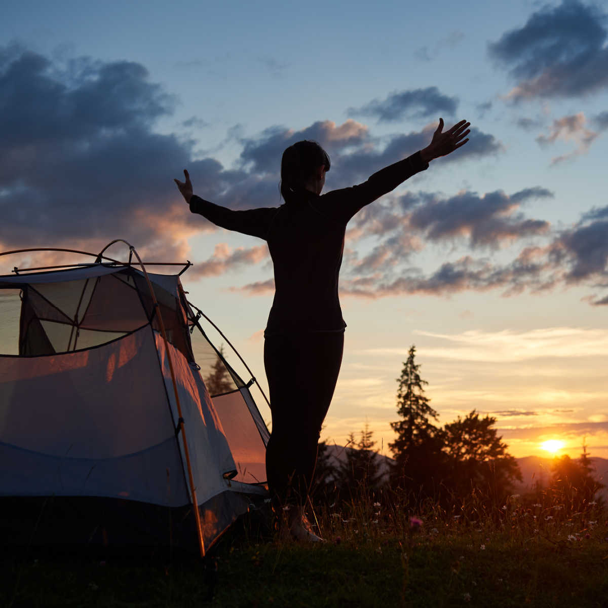 Woman at campsite at sunset